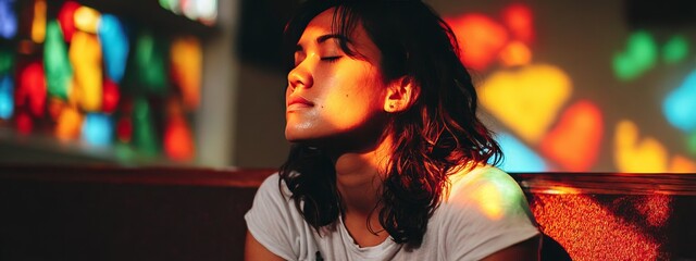 Single woman praying inside softly lit church, stained glass light, Santiago Festival celebration