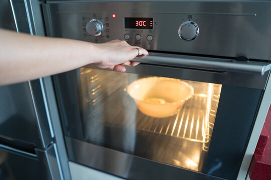 Woman preparing focaccia bread in modern kitchen