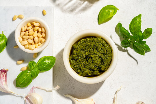 Top view of fresh pesto ingredients with basil and garlic