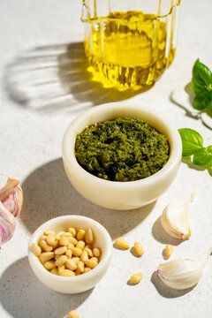 Ingredients for pesto preparation on a white background