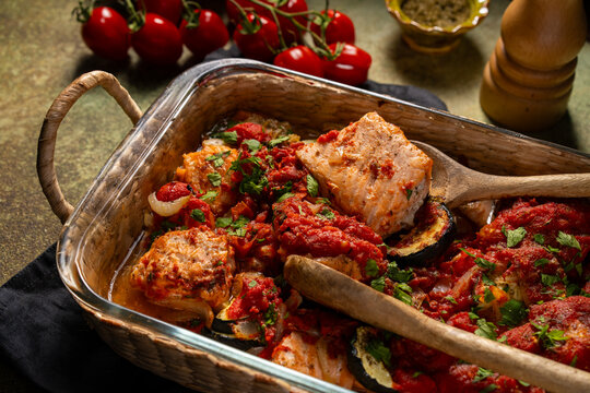 Baked salmon with vegetables in tomato sauce