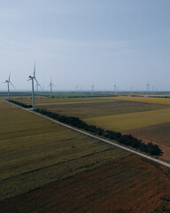 Aerial photography: Wind turbines producing clean energy. Wind farm. Top view of agricultural...