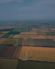 Aerial photography: Wind turbines producing clean energy. Wind farm. Top view of agricultural...