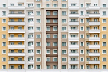 Frontal view of a beige modern apartment building with multiple balconies