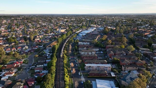 Drone Shot of Sydney Suburban Train at Sunset Flying Over Sefton to Lidcombe