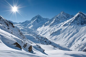 Fototapeta premium Bright sun shining over snowy mountain peaks in the alps