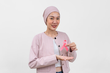 Happy asian woman cancer patient holding cancer awareness ribbon campaign ribbon to symbolize her...