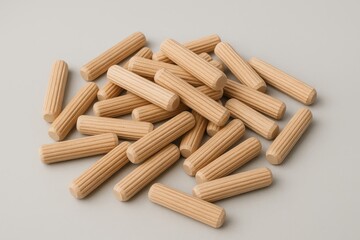 Stack of wooden dowels on a soft grey backdrop