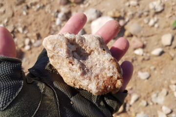 Quartz-chalcedony secretion found in a quarry lies in a hand, search for stones and minerals