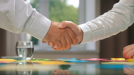 Business Agreement Handshake Over a Modern Conference Table