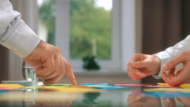 Hands Collaborating in Creative Team Meeting with Sticky Notes