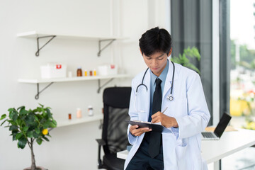 Doctor at Work. A healthcare professional taking notes on a tablet in a modern clinic.