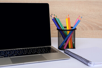 A Modern Workspace Setup that Includes a Laptop and Various Stationery Items for Efficiency