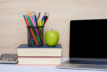 A contemporary modern study workspace featuring a laptop alongside stationery items setup
