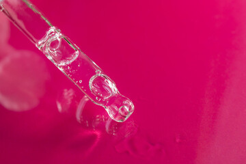 An eyedropper with a drop of oil or a cosmetic product for face and body. Natural organic cosmetics. The concept of body care.