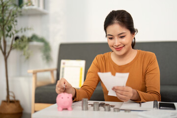 Budgeting: Woman Counting Money with Piggy Bank