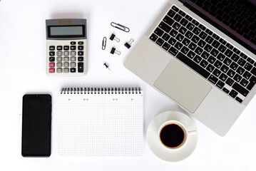 A modern office space with a laptop, calculator, and coffee for productivity and creativity
