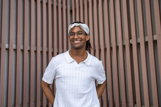 Queer individual enjoying a summer day by a wooden slats