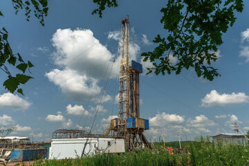 Drilling a well in an oil field. Mobile drilling rig and drilling equipment. Summer. Beautiful sky...