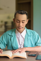 portrait of a young non binary gay man doctor reading book