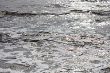 Ocean Waves Glistening Under Sunlight with Foamy Patterns