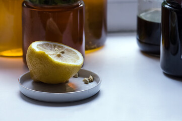 honey in a glass jar with a lemon on the windowsill