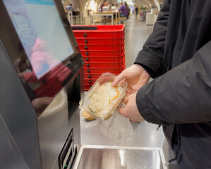 Self-checkouts or self-service checkouts,man paying for the purchases  in supermarkets