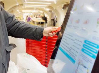 Self-checkouts or self-service checkouts,man paying for the purchases  in supermarkets