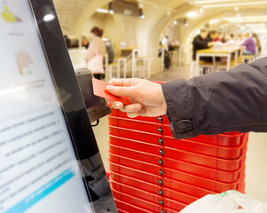 Self-checkouts or self-service checkouts,man paying for the purchases  in supermarkets