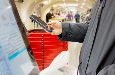 Self-checkouts or self-service checkouts,man paying for the purchases  in supermarkets