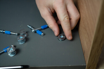 teenager assembles furniture according to instructions