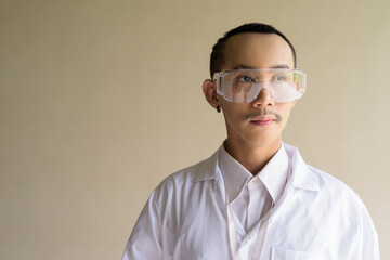 portrait of a young scientist gay man wearing safety glass goggles
