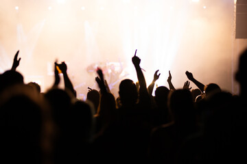 Crowd at concert and blurred stage lights.