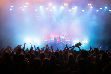 Crowd at concert and blurred stage lights.