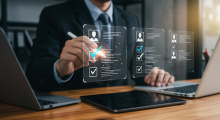 Digital Assessment: A focused professional utilizes modern technology to review digital profiles and resumes, showcasing precision and innovation in the hiring process.