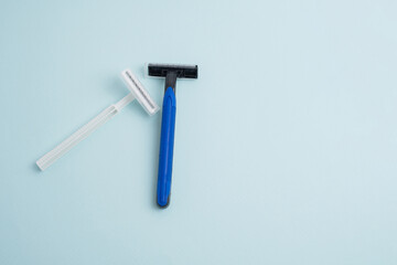 Disposable plastic razor with steel blade, men's and women's razors. Skin and body care concept. Depilation. Place for text 

