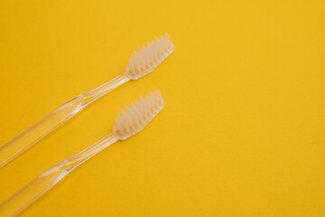 White toothbrushes on a color background. Replace your old toothbrush with a new one. Old and new...