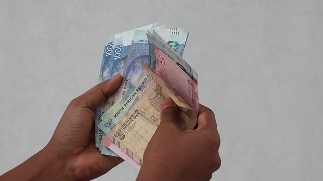 Female hand counting South African Rand banknotes. Close up of ZAR currency notes 20, 50, 100 Rand. Finance and economy concept HD video.