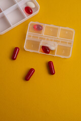 Pill box with various pills, vitamins and dietary supplements for every day. Space for text.