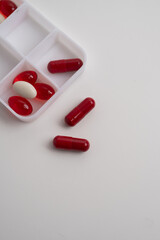 Pill box with various pills, vitamins and dietary supplements for every day. Space for text.