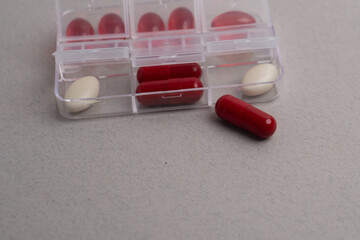 Pill box with various pills, vitamins and dietary supplements for every day. Space for text.
