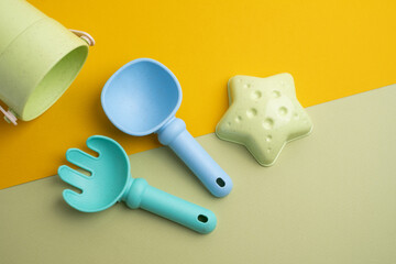 Children's toys, a shovel, a rake and crispy colorful snacks. Summer mood on the beach