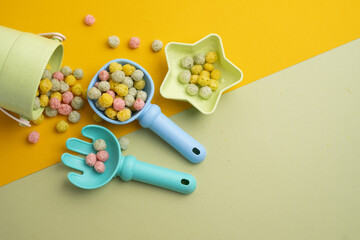 Children's toys, a shovel, a rake and crispy colorful snacks. Summer mood on the beach