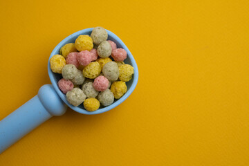 Children's toys, a shovel, a rake and crispy colorful snacks. Summer mood on the beach