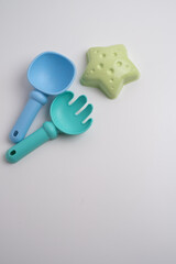 Children's toys, a shovel, a rake and crispy colorful snacks. Summer mood on the beach