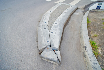 Broken concrete barrier before and after the pedestrian crossing, infrastructure decay, need for...