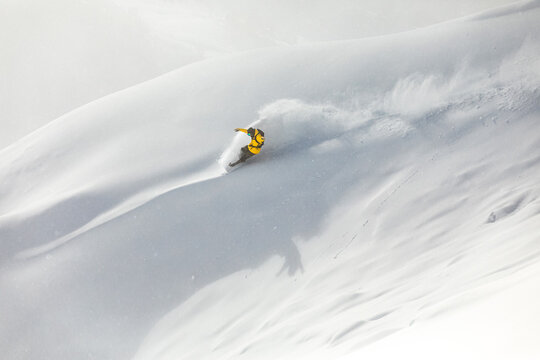 Man snowboarding freeride on a powdery slope