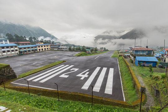 Scenic view of Lukla airport amidst misty Nepal mountains