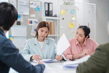 diverse business professionals engage in a dynamic brainstorming meeting, analyzing AI-powered...