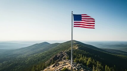 American flag waving on a mountain peak with a vast wilderness landscape view. - Powered by Adobe
